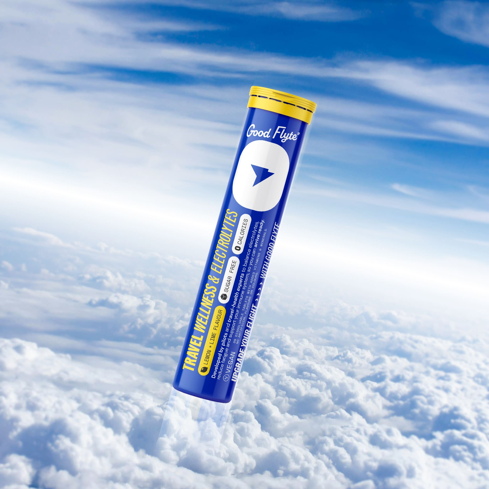Good Flyte Travel Wellness & Electrolytes tube against a backdrop of clouds in the sky.